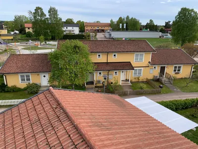 Före: gula radhus med bruna tak och betongpannor i förgrunden med smuts och mossa, Skattkärr