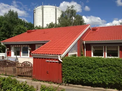 Efter: nymålade röda tak hos BRF Österhöjden med vattentornet i bakgrunden