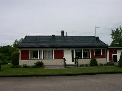 Efter: röd villa med ljus tegelsockel och färdigbehandlat antracittak